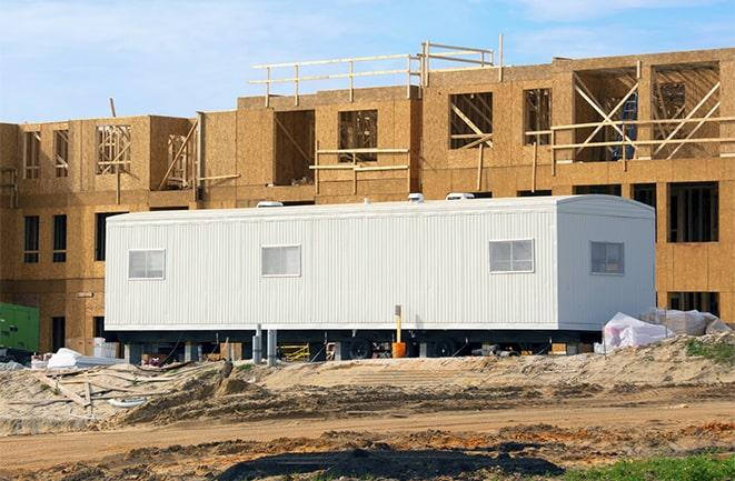 crane lifting modular building for construction office rentals in Ocean Ridge